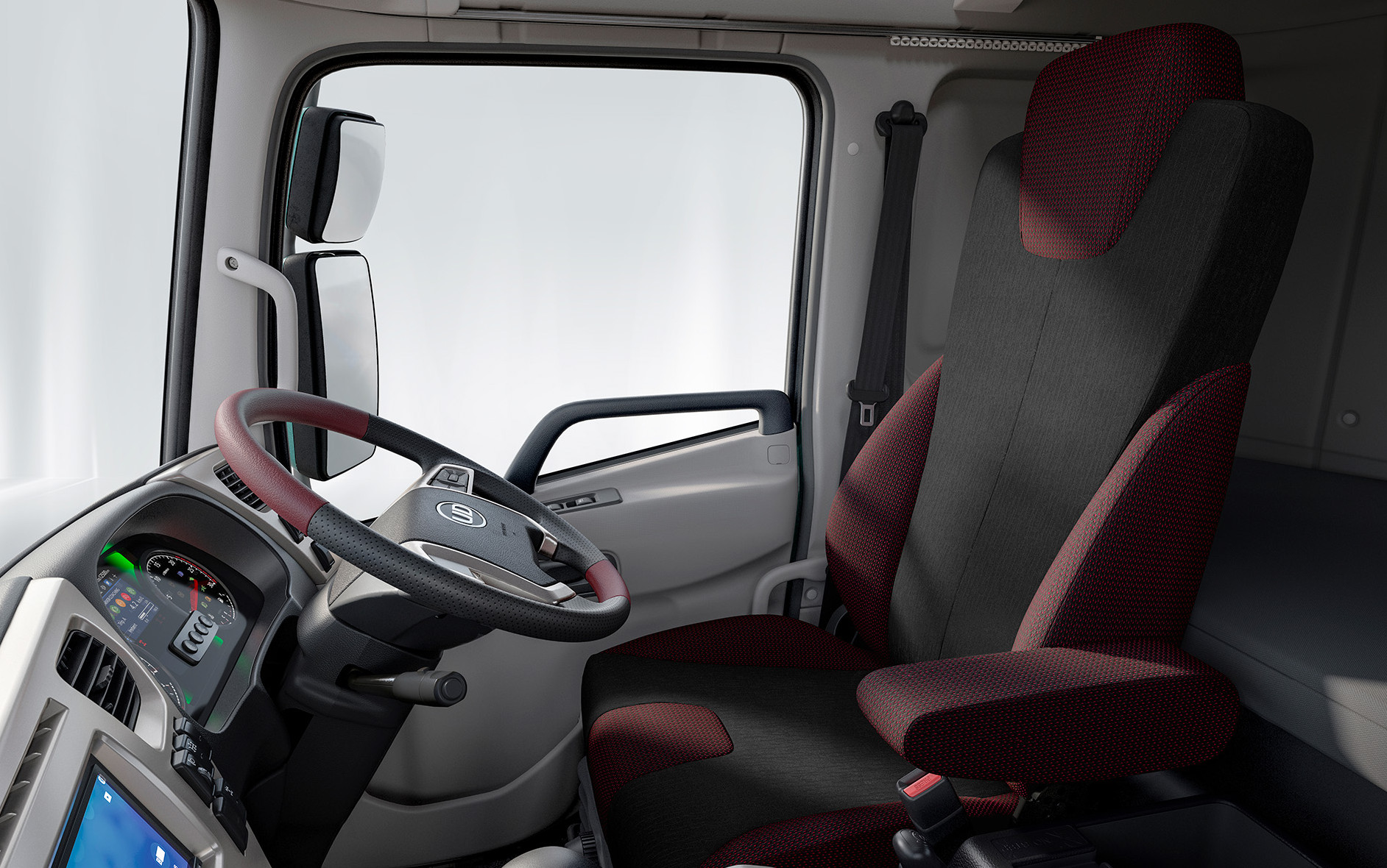 Modern truck cabin interior with maroon and black driver's seat and digital dashboard.