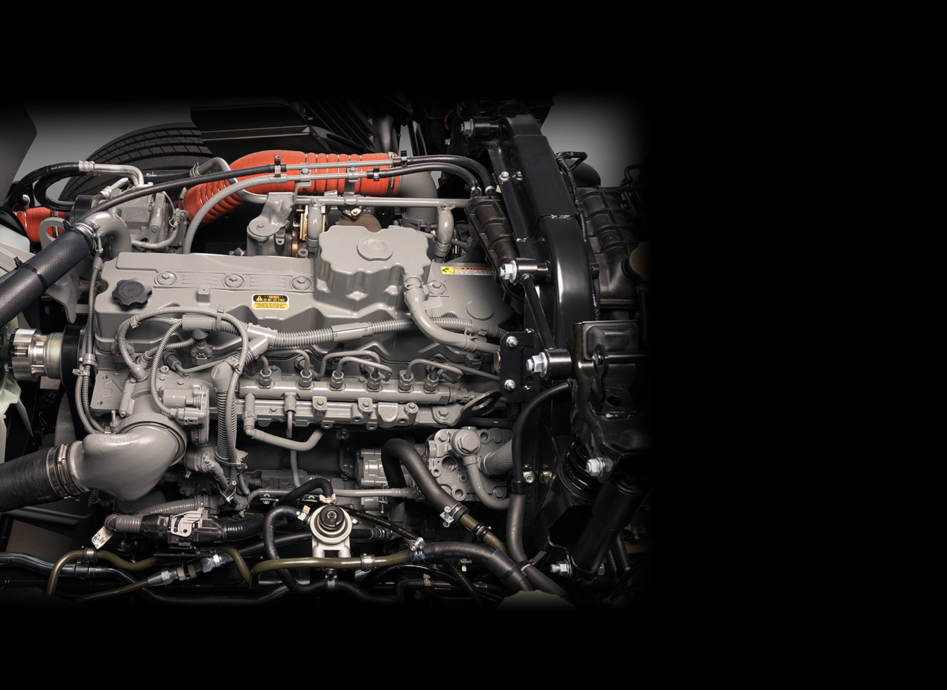 Close-up of a car engine with visible pipes and components.