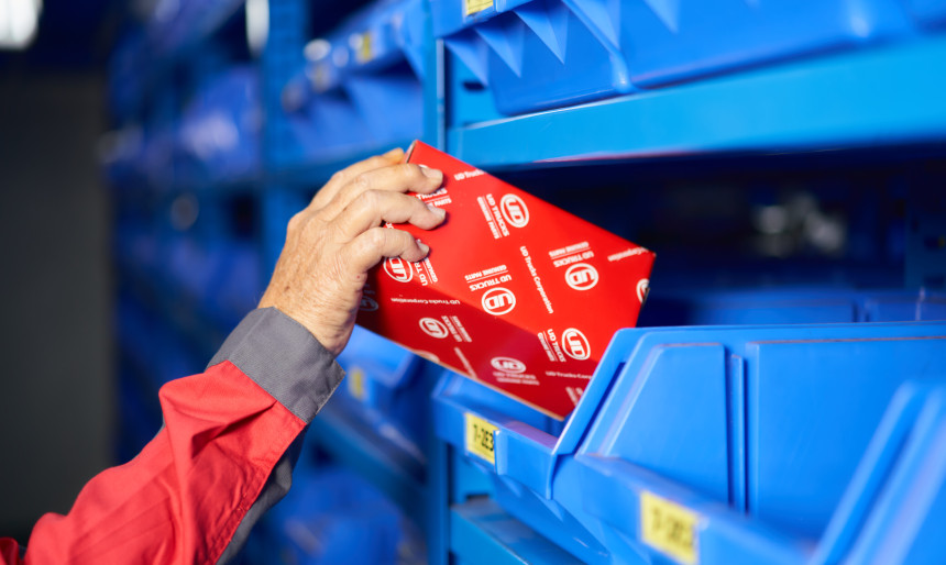 UD Genuine Parts being selected from large parts store.