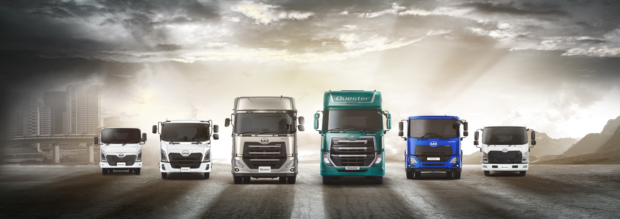 Six trucks of different sizes lined up under a dramatic, cloudy sky.