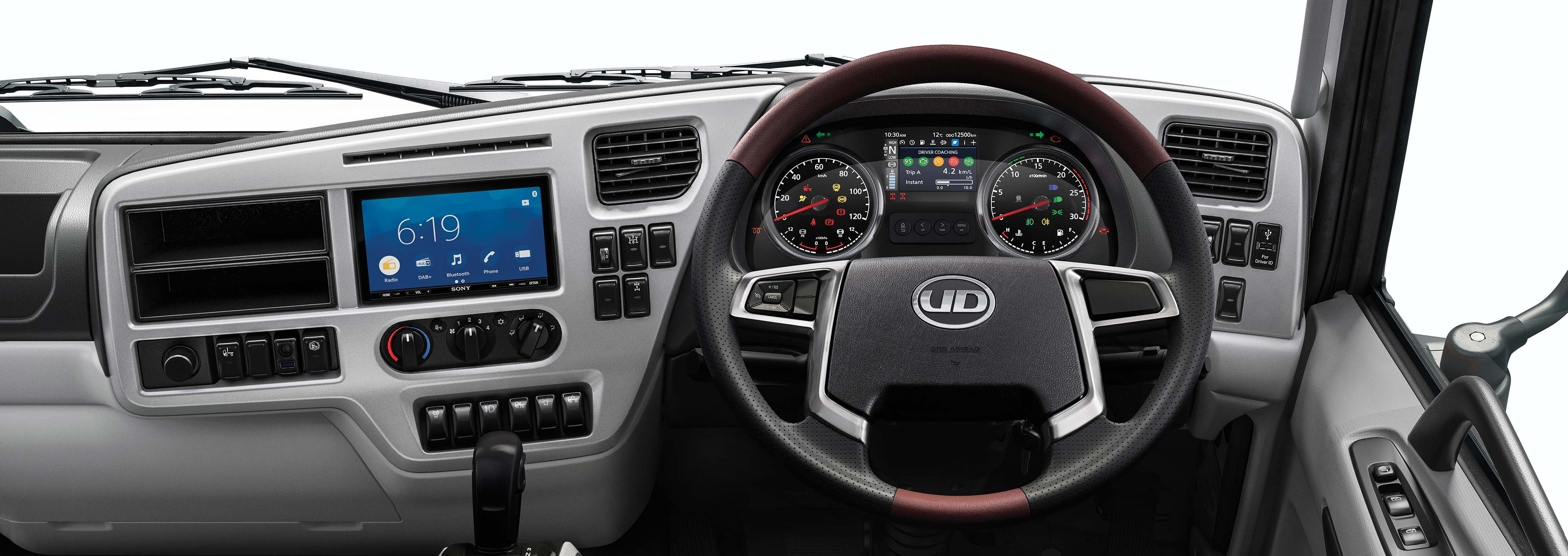 Modern truck dashboard with steering wheel, digital display, and control panels.