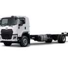 White flatbed truck chassis with no cargo, facing left on a white background.